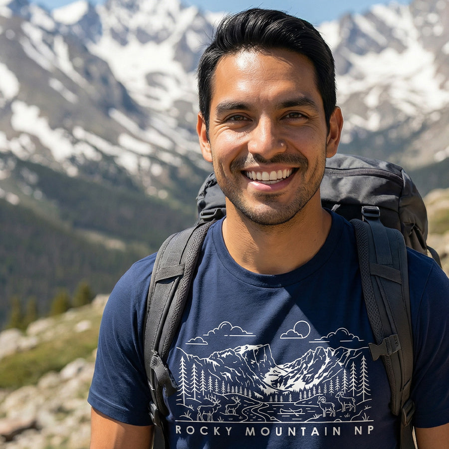 Man hiking a trail wearing a navy Grand Teton National Park Line Art Tshirt.