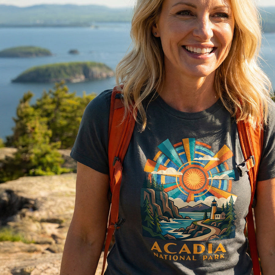 Model wearing radiant sunburst Acadia National Park Charcoal T-Shirt hiking Cadillac Mountain.