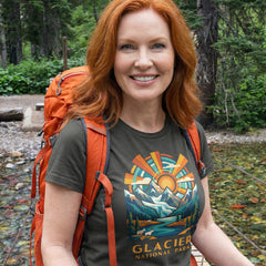 Model wearing radiant sunburst Glacier National Park Charcoal T-Shirt hiking.