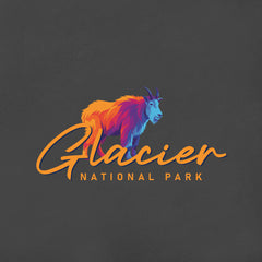 Glacier – Mountain Goat Script T-Shirt features a stylized, multicolored mountain goat above "Glacier" in orange script and "National Park" in uppercase on a dark background—a perfect Montana souvenir or mountain goat gift.