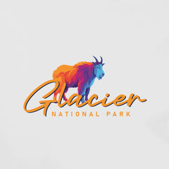 The Glacier – Mountain Goat Script T-Shirt features a colorful, stylized mountain goat above “Glacier National Park” in orange script on a white background—a perfect Montana souvenir for mountain goat and park enthusiasts.
