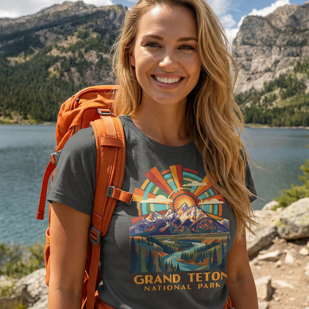 Model wearing radiant sunburst Grand Teton National Park Charcoal T-Shirt hiking Phelps Lake.