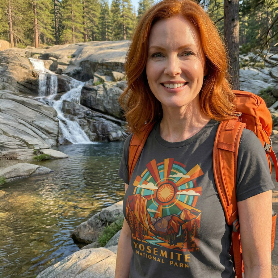 Model wearing radiant sunburst Yosemite National Park Charcoal T-Shirt hiking.